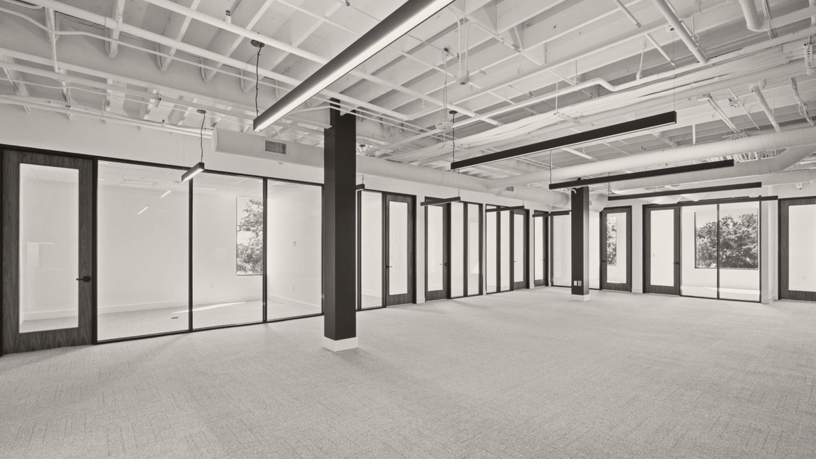 Open office floor with glass-front private offices
